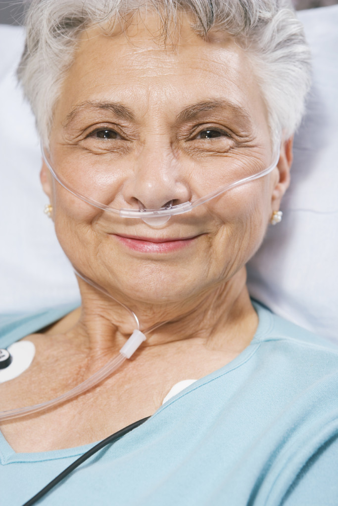 Senior woman sitting in the stretcher